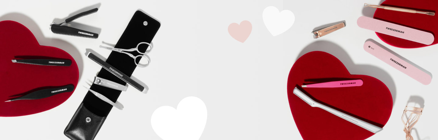 Red, white and pink hearts with an assortment of Tweezerman beauty tools for Valentines Day.