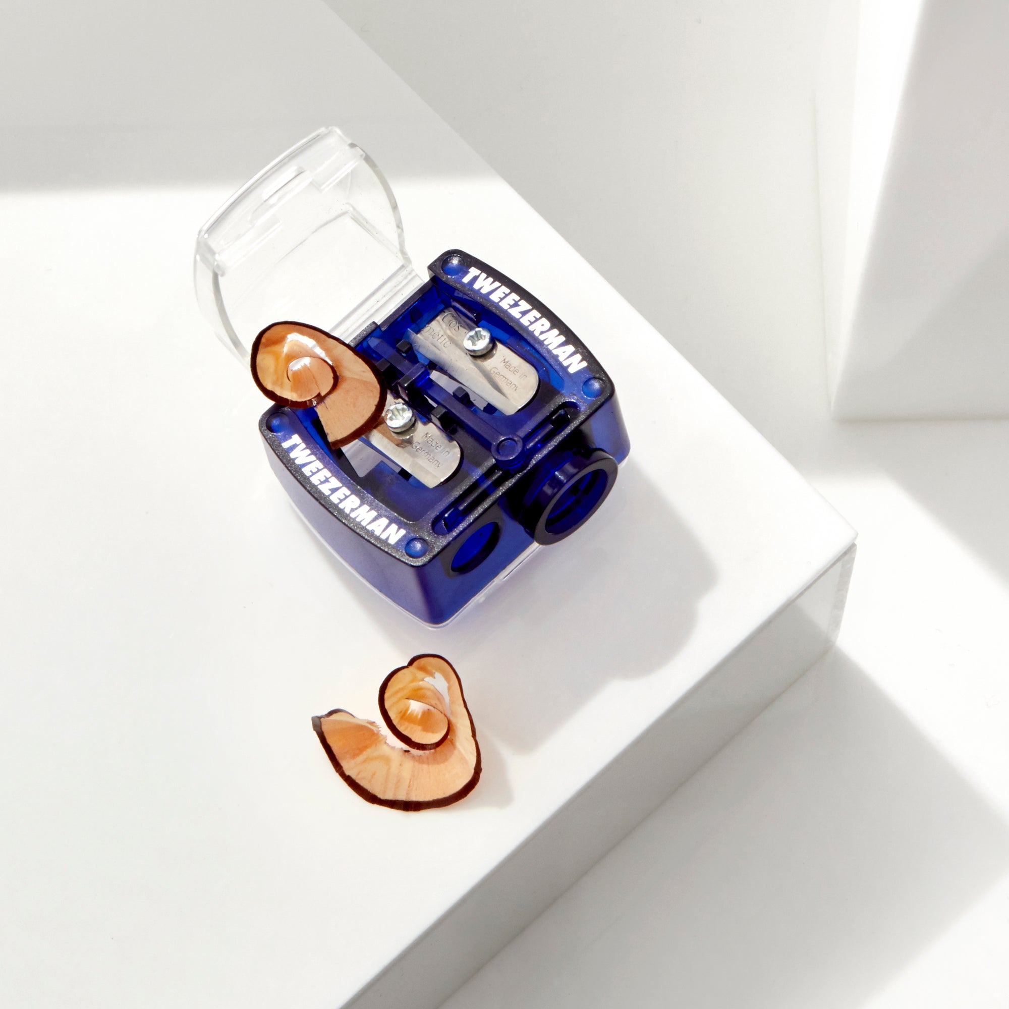 Opened Blue Cosmetics Pencil Sharpener with shavings