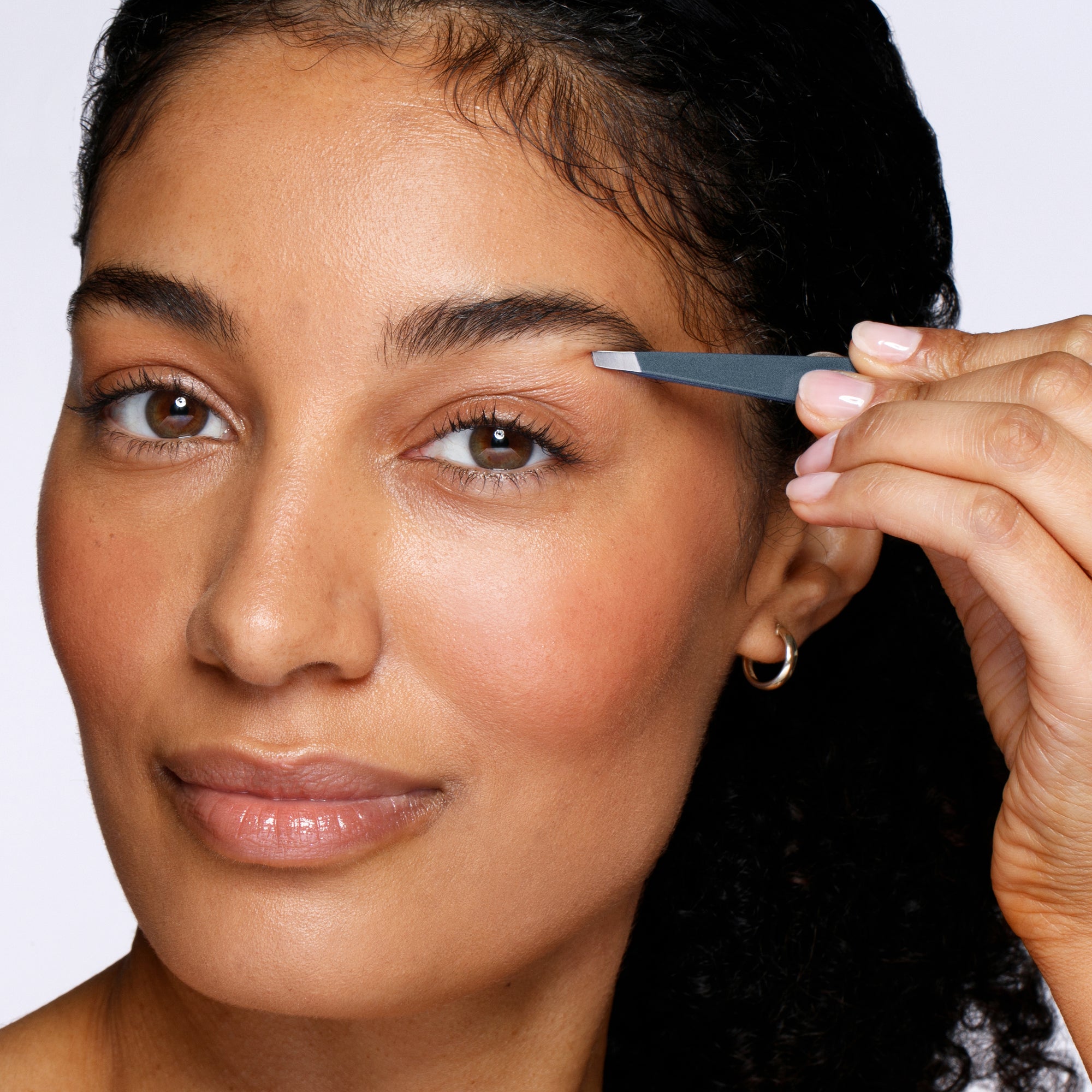 Female Model using Blue Stone Slant Tweezer on brows