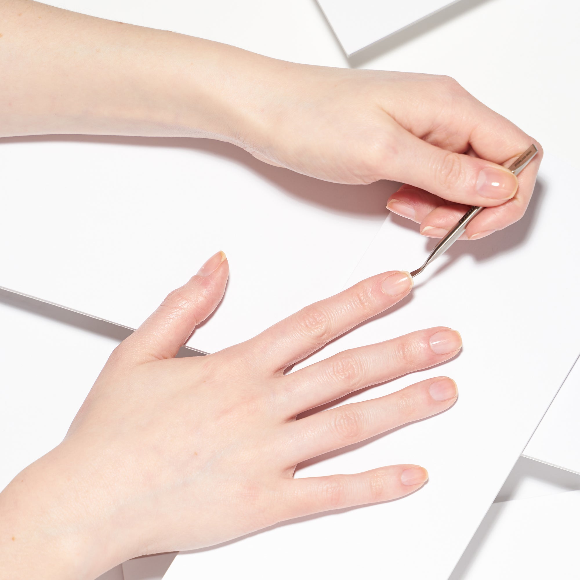 Model using mini dual ended nail pushy and cleaner