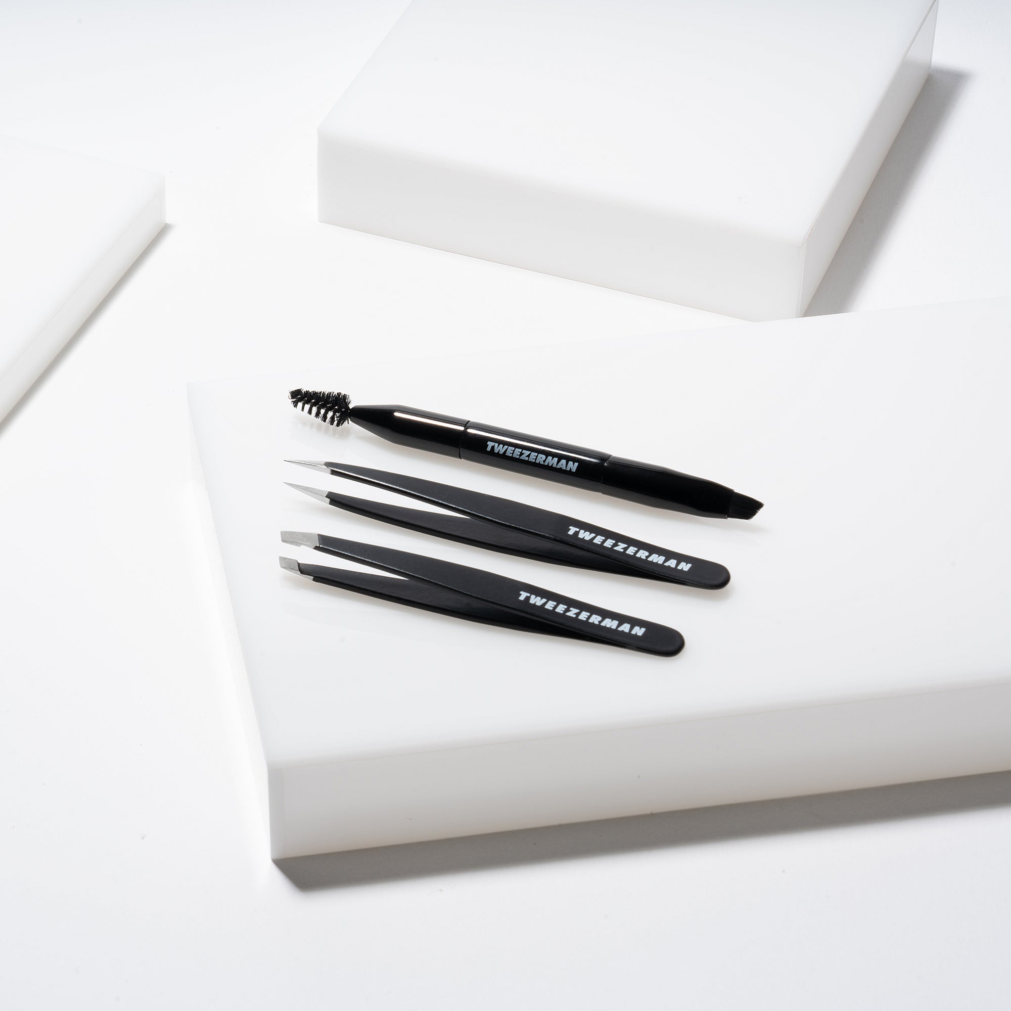 Mini Dual ended Brow Brush and spoolie with black point tweezer and black slant tweezer