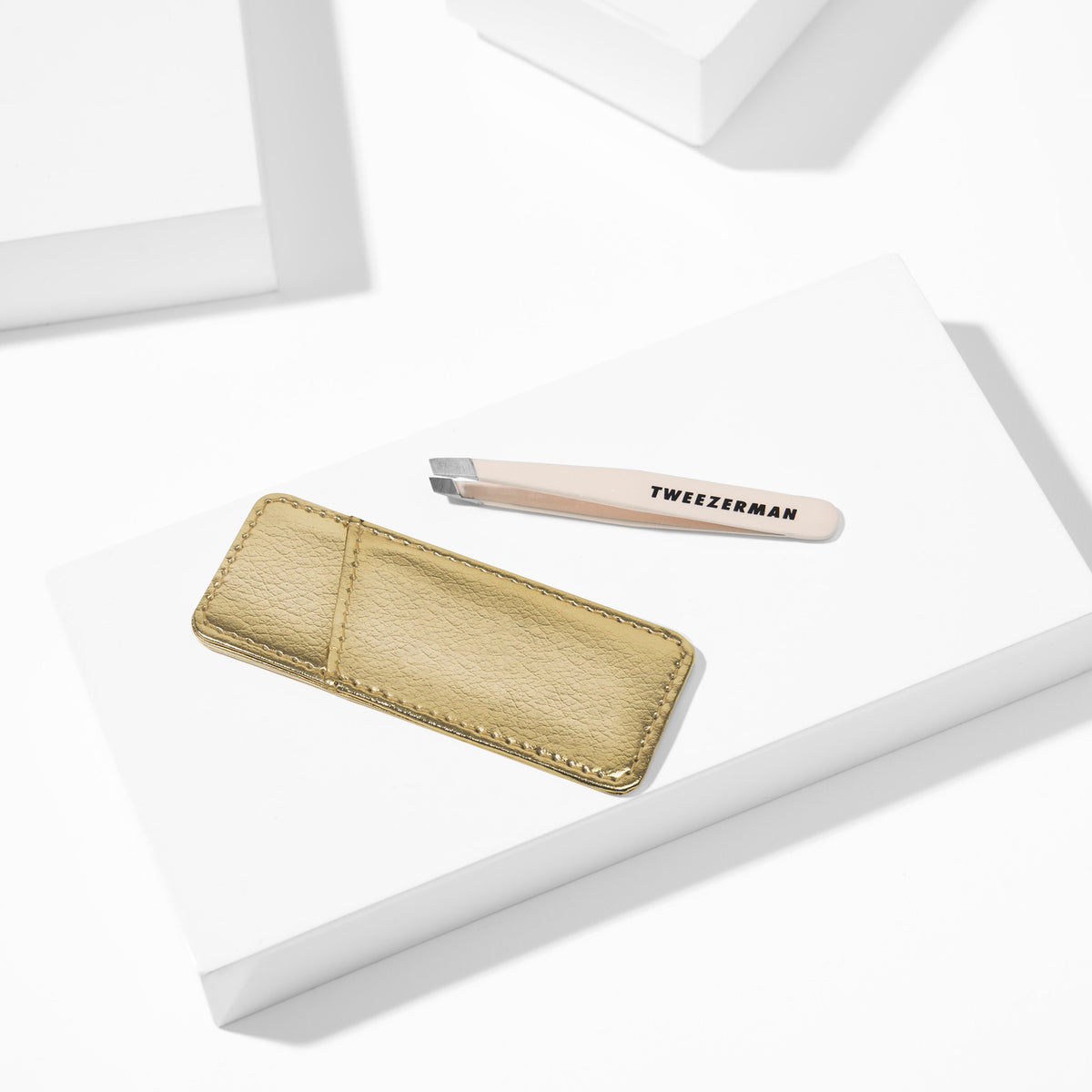 Evening Glow Mini Slant Tweezer with Case placed on white block tray