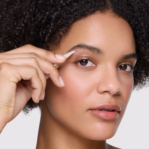 Model is using slant tweezer of the Evening Glow Micro Mini Tweezer Set