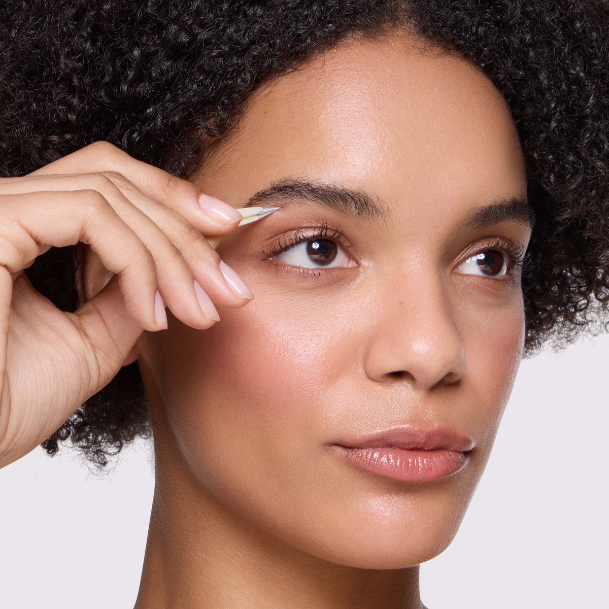 Model is using point tweezer of the Evening Glow Micro Mini Tweezer Set
