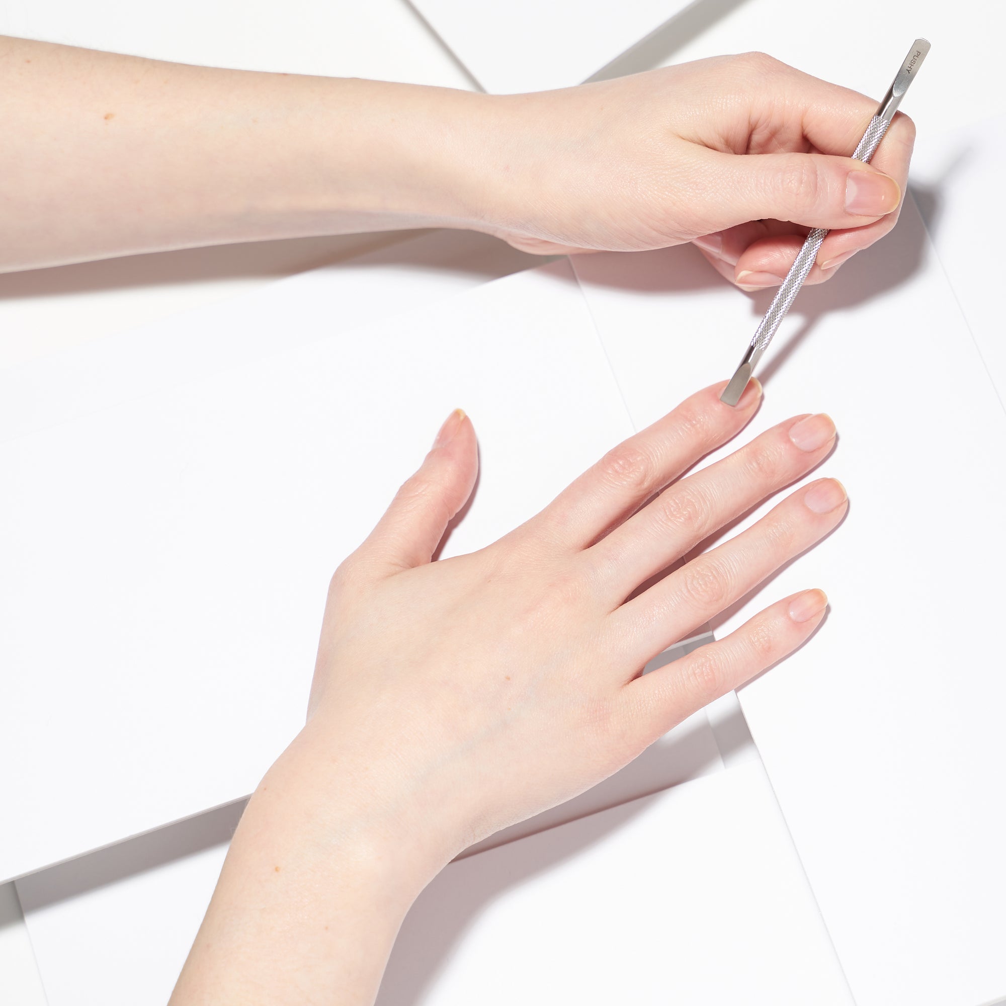 Model using flat end of dual ended stainless steel pushy