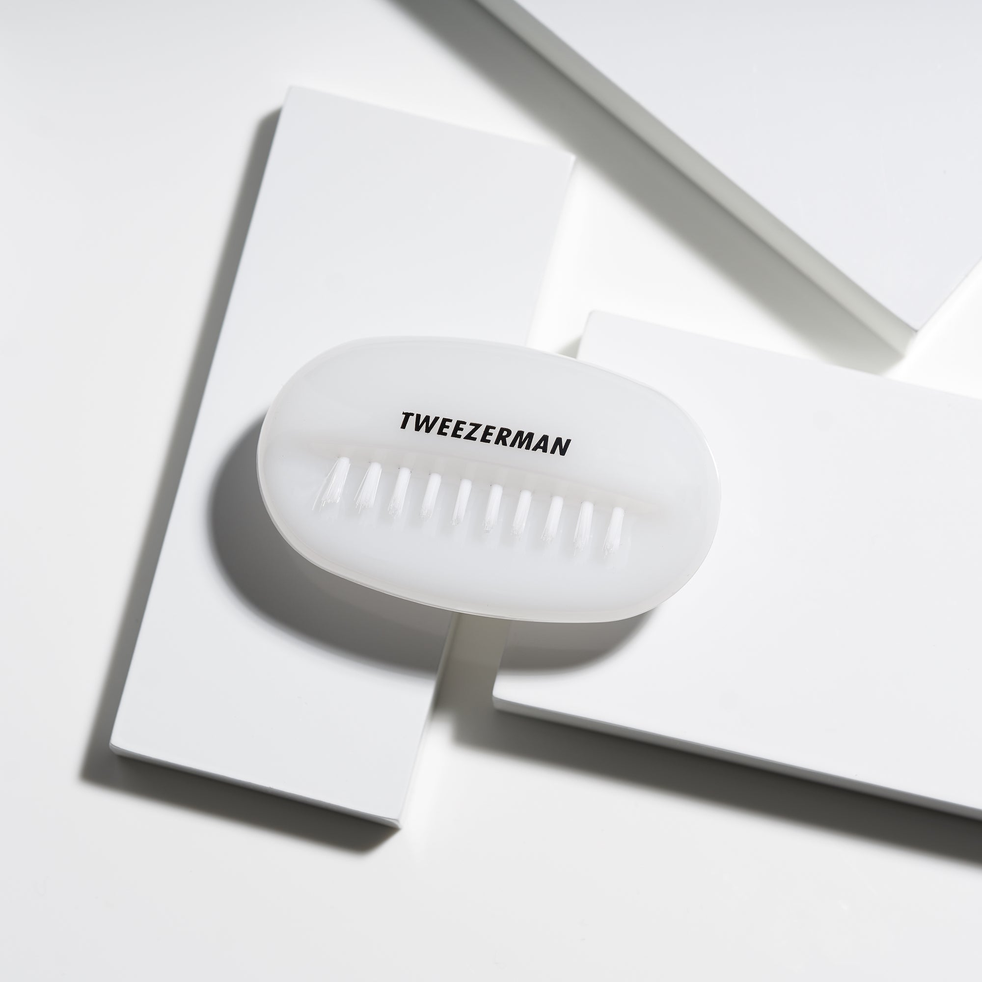 White oval shaped dual nail brush top view