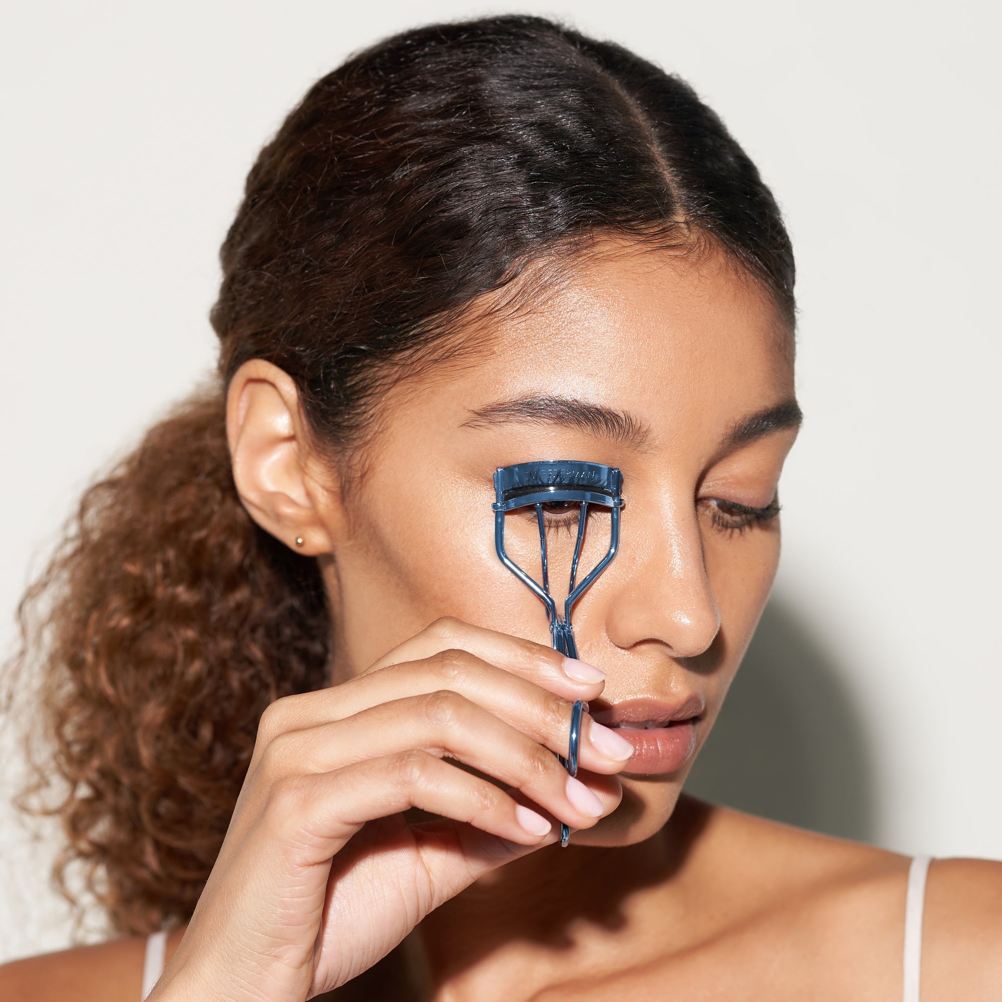 Model using Blue Classic Lash Curler