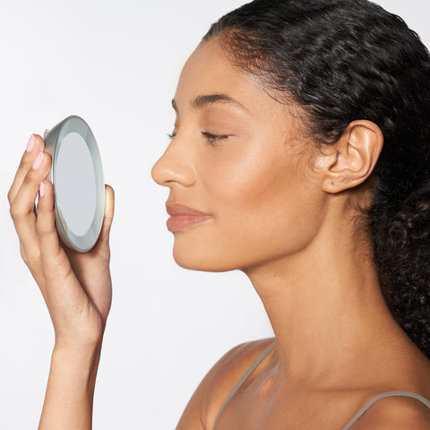 Model using LED lighted 15x mini mirror