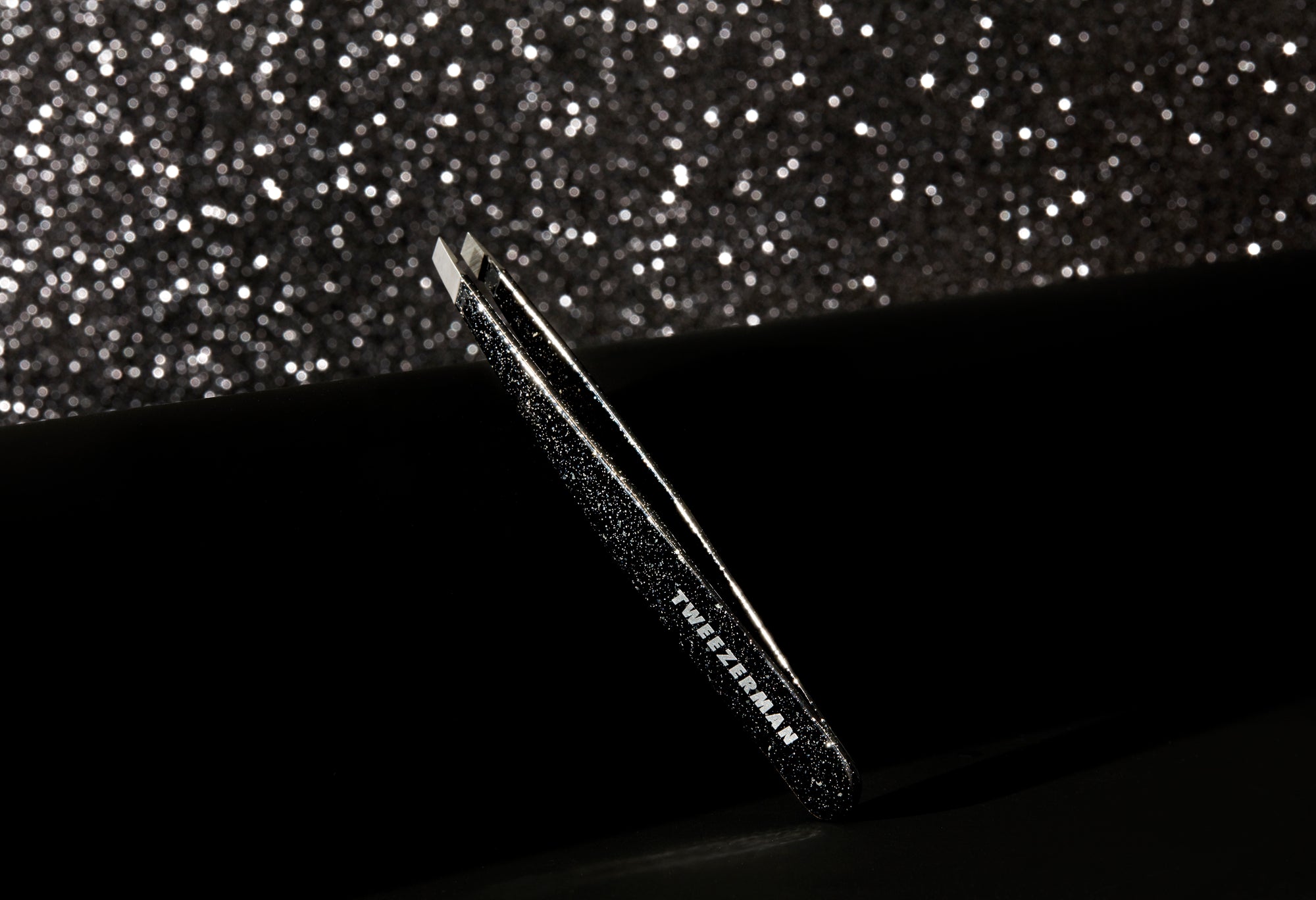 Model Using Dusted Onyx Slant Tweezer