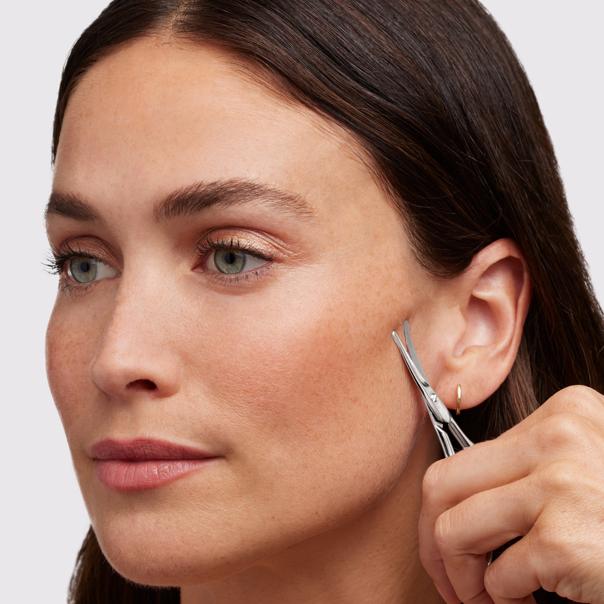 Female model using Stainless Steel Facial hair Scissors on face