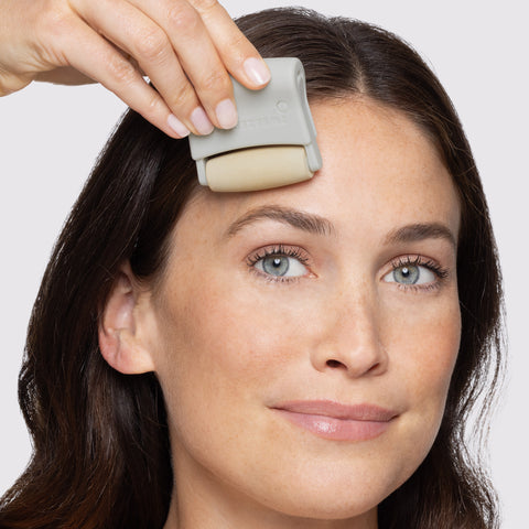 Modeling USING 3-in-1 Facial Roller set, Volcanic Stone ON FOREHEAD