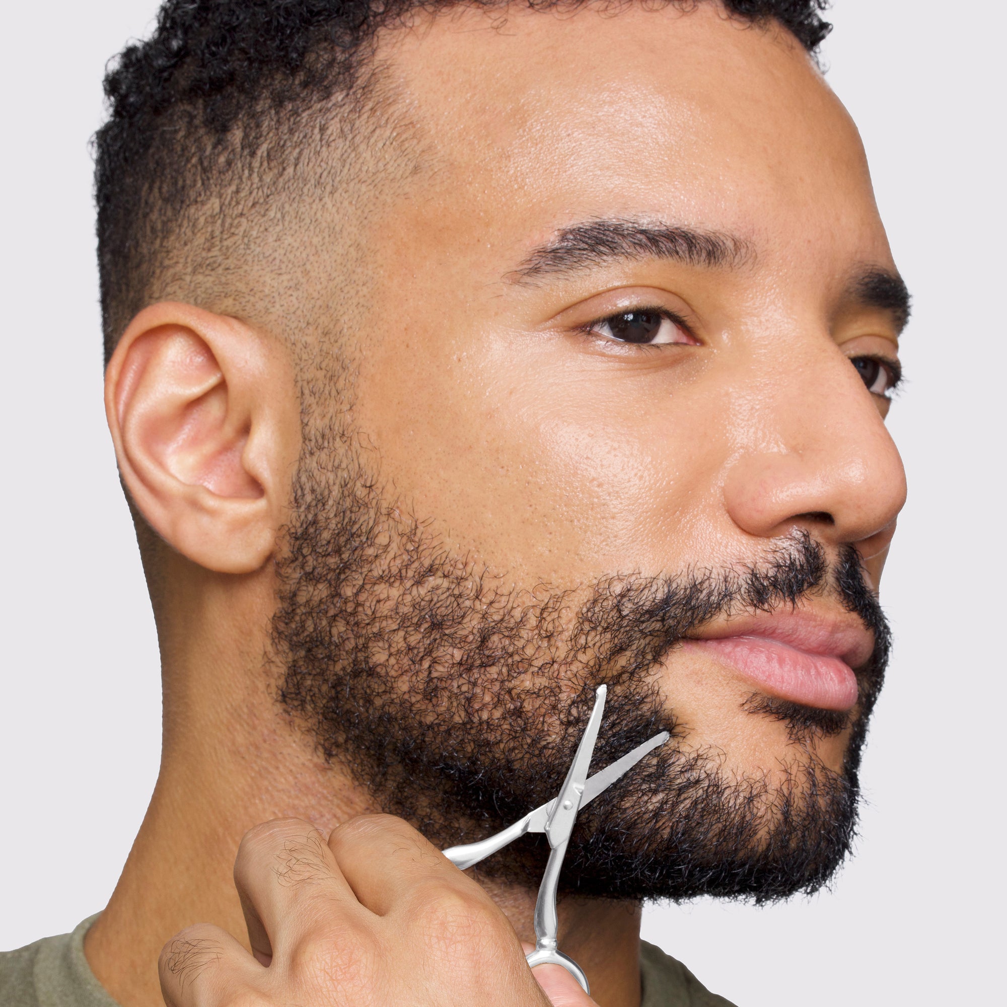 Male model using Stainless Steel Facial hair Scissors on bread