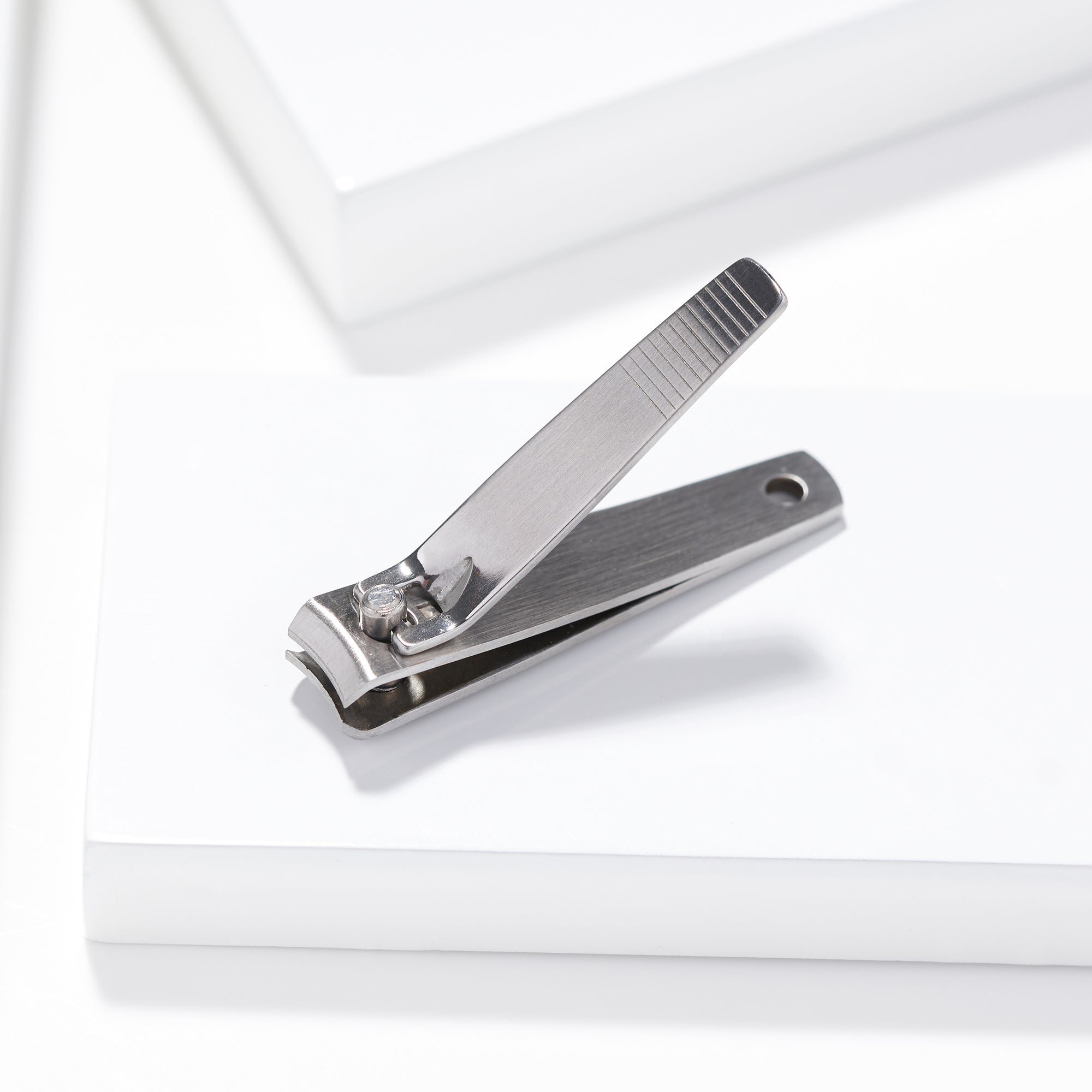 Stainless steel fingernail clipper with lever raised
