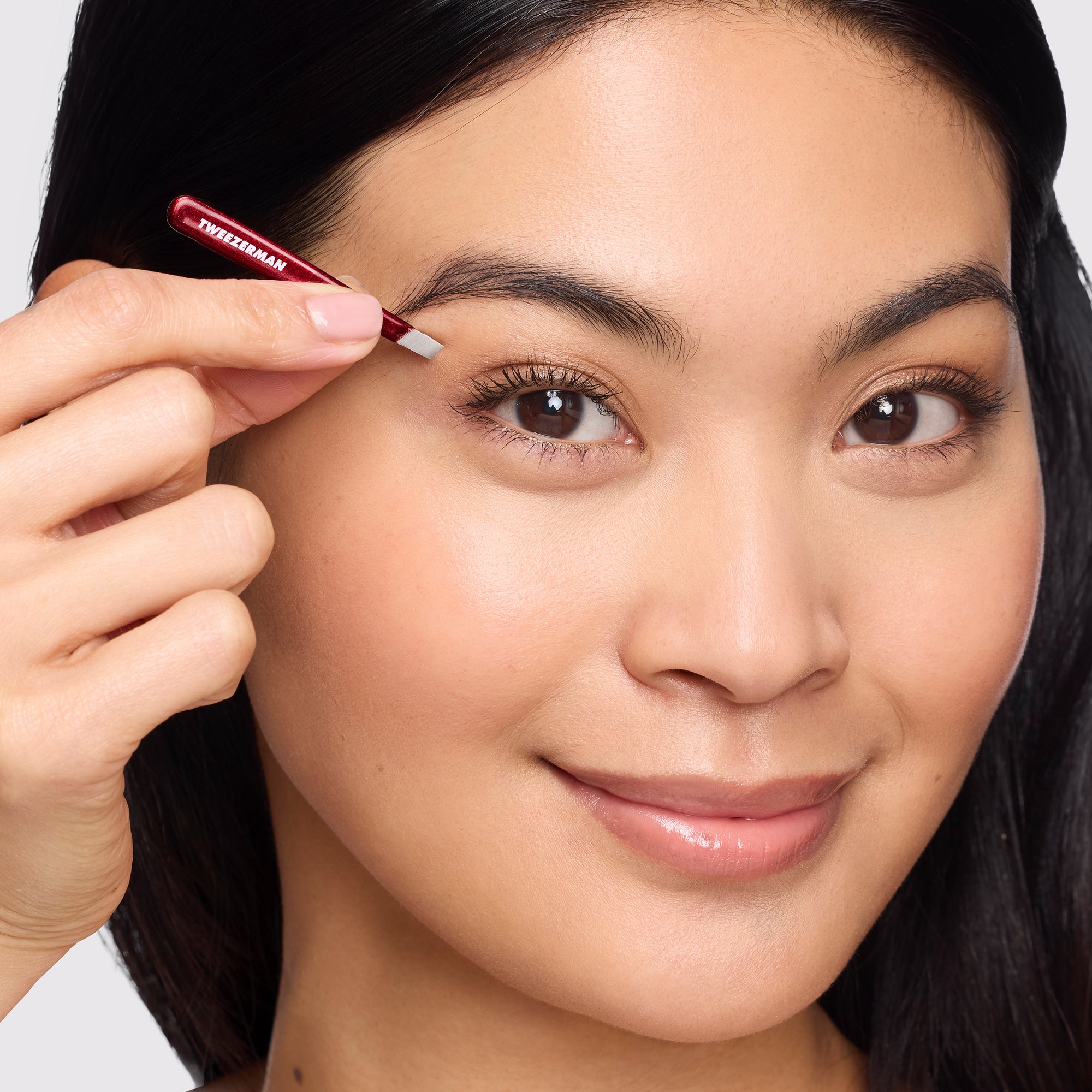 Model holding Vintage Rose Micro Mini Slant Tweezer